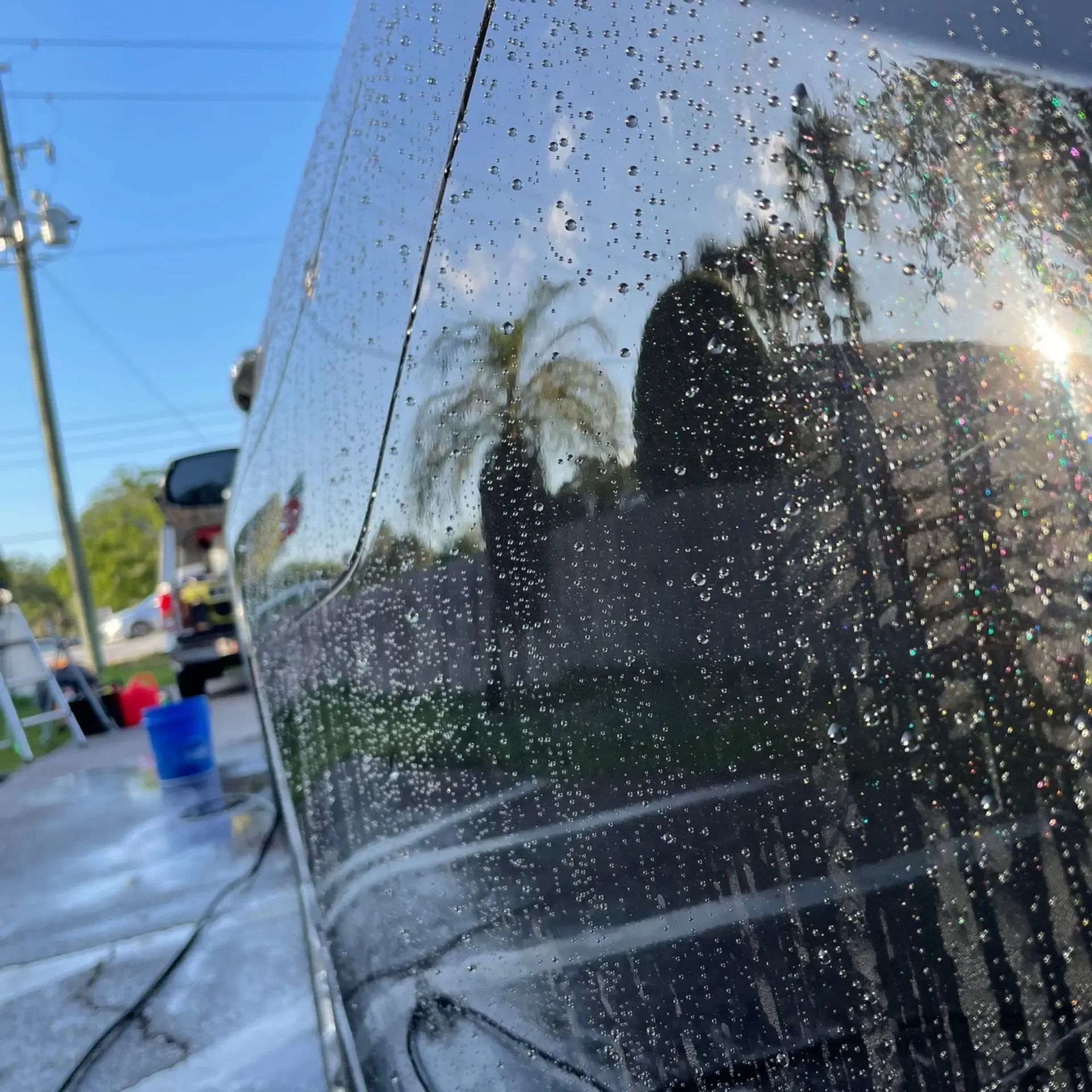A car is being washed with soap and water at a car wash.